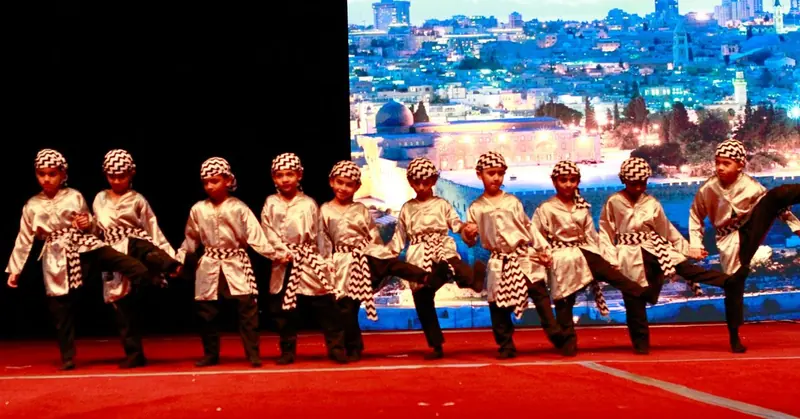A line of students performing a folk dance